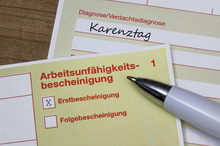 Auf einer Arbeitsunfaehigkeitsbescheinigung befindet sich die Diagnose Karenztag.