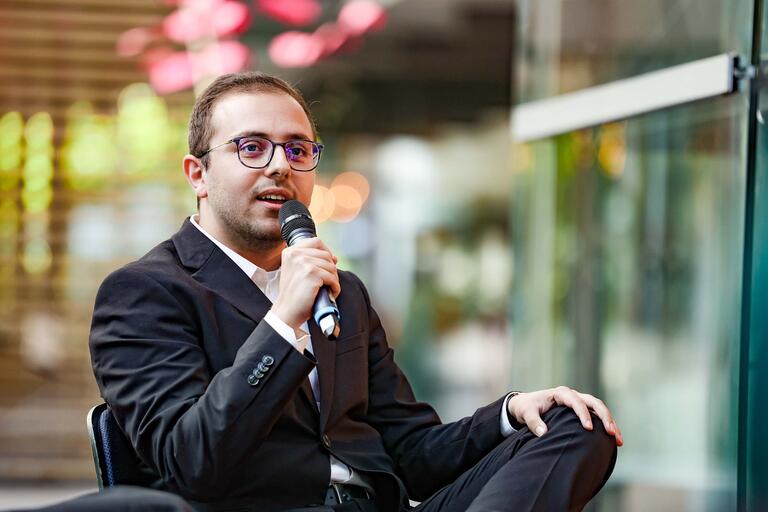 Foto von HBS-Stipendiat Adrian Radosta mit Mikro in d. Hand bei Diskussionsrunde während der Ruhrfestspiele